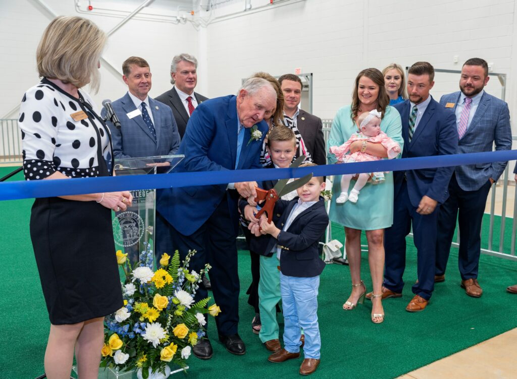 Tom McCall cutting the ribbon with the help of some children